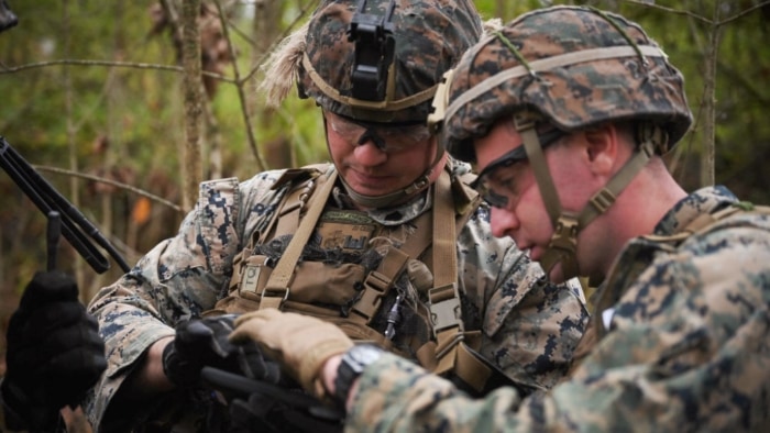 Marines using device in wooded area